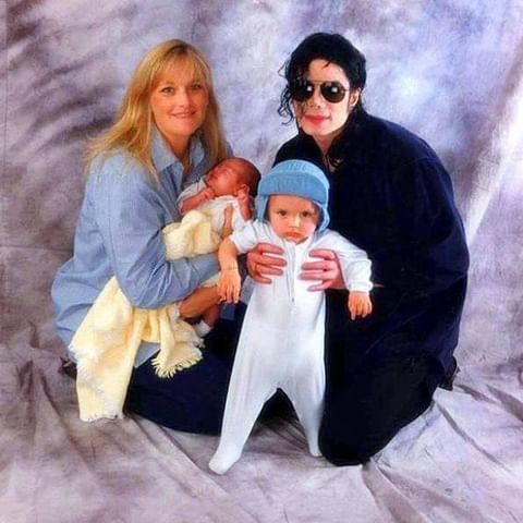 Debbie Rowe and Michael Jackson with their children